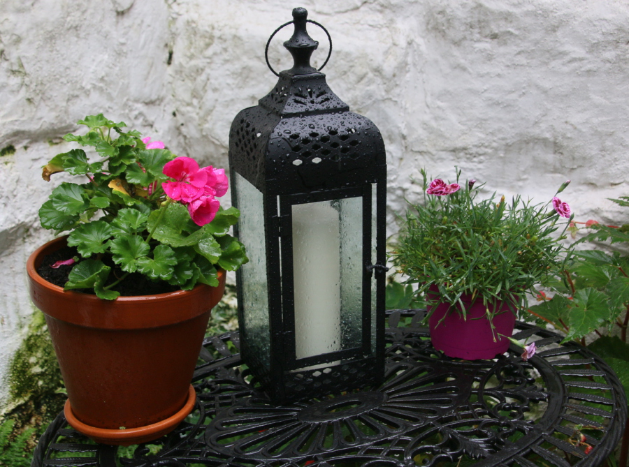 Lantern with pillar candle on table